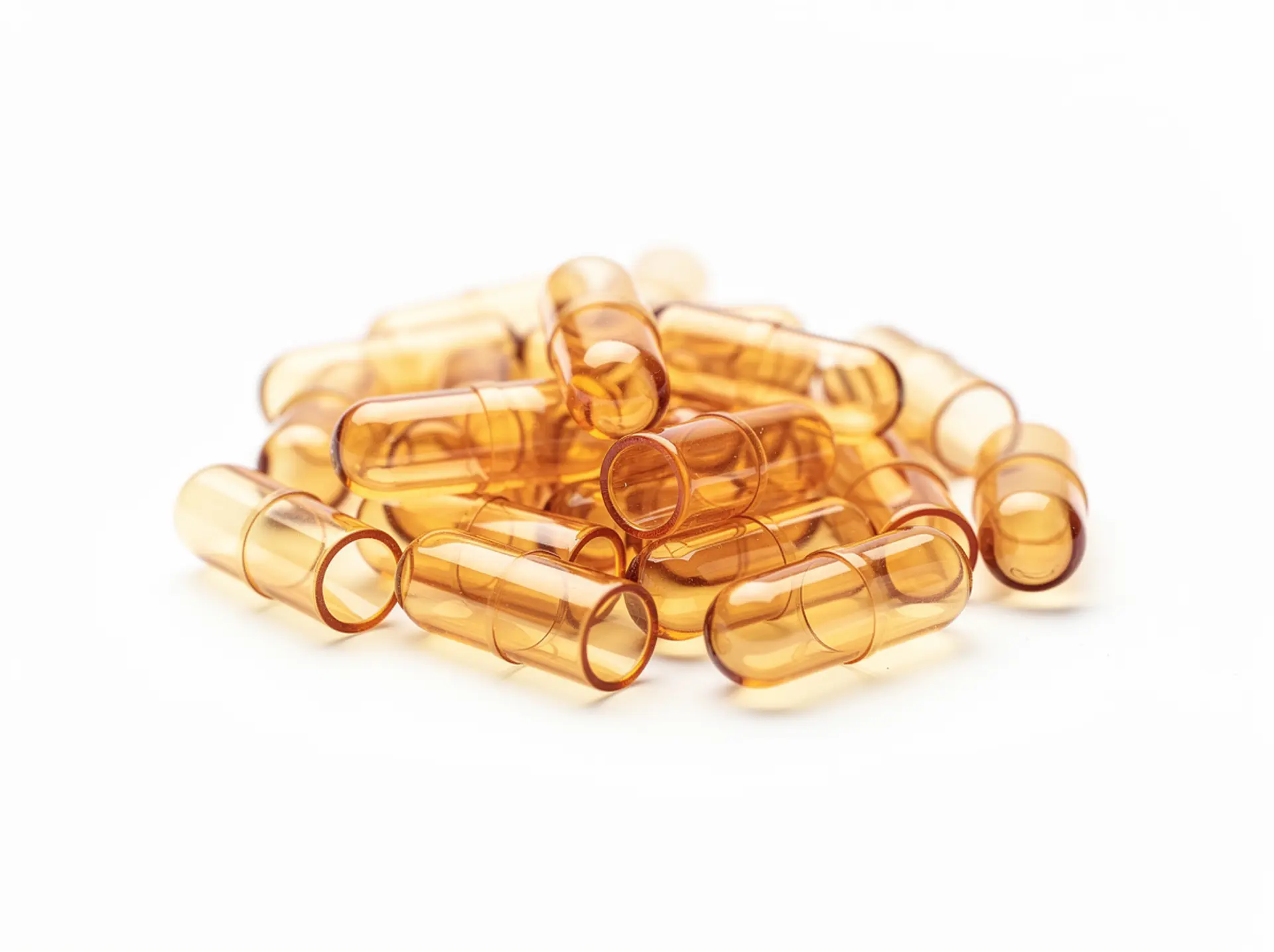Empty two-piece bovine gelatine hard capsule shells in a warm amber tone